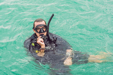 Divers on the surface of water ready to dive