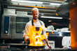 © ADDICTIVE STOCK - Cook making flambe in restaurant