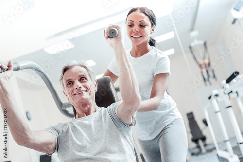 Helping Her Patient Inspired Old Grey Haired Man Exercising On A