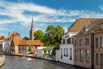 Wall Mural - Typical medieval Flemish architecture of Bruges, Belgium. Red brick houses standing on the banks of canals.