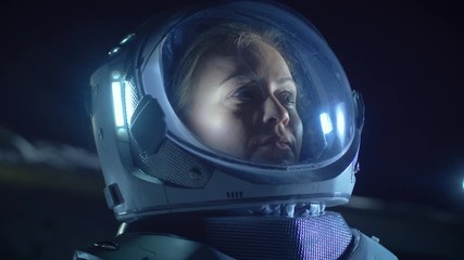 portrait of the beautiful female astronaut on the alien planet looking around in wonder. in the back