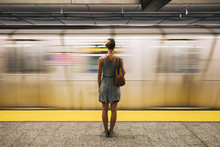 Young Woman Waiting For Subway Train In New York City