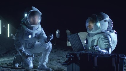 Wall Mural - two astronauts collect rock and soil samples on the alien planet. space travel and exploration, find