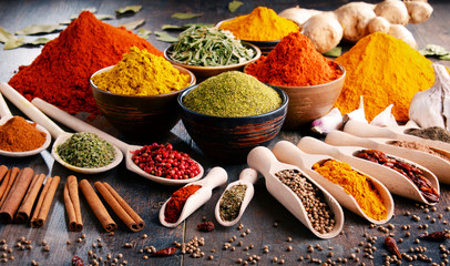 Wall Mural - Variety of spices and herbs on kitchen table