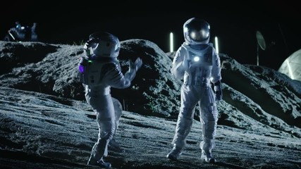 Wall Mural - male and female astronauts wearing space suits dance on the surface of the alien planet. humanity co