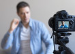 © M-Production - Handsome man making video blog. Focus on camera.