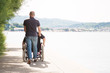 Senior In Wheelchair Spending Time Outdoors With His Nurse