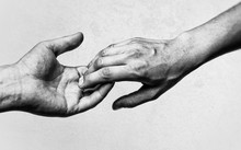 Emotional, Black And White Photo Of Two Hands At The Moment Of Farewell. The Concept Of Breaking Relations.