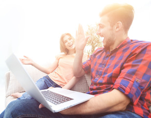 Wall Mural - young man and his girlfriend giving each other a five in the sign of success