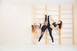 © Aleksei Lazukov - two girls standing in twine at sports wall