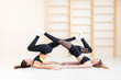 © Aleksei Lazukov - two young women doing each other stretching their legs on shoulder blades