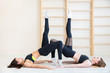 © Aleksei Lazukov - two beautiful girls on floor stretch their legs in  stretching up