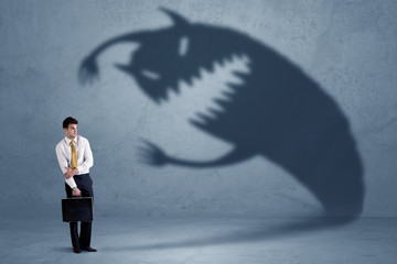 Wall Mural - Business man afraid of his own shadow monster concept