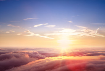 Wall Mural - beautiful aerial view above clouds with sunset.