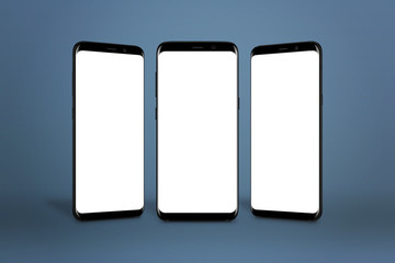 Leinwandbilder - Three modern smartphones with round edges and isolated screen for mockup on blue background.