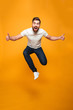 canvas print picture - Full length portrait of an excited bearded man jumping