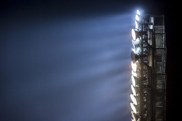 Wall Mural - Light tower lit at a stadium during nightime.