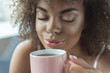 © Yakobchuk Olena - This beautiful smell. Portrait of close up cheerful female face tasting cup of appetizing tea