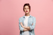 © master1305 - The serious business woman standing and looking at camera against pink background.