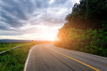 Empty road with clouds, trees and sunlight for background