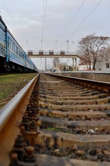 Railway station against beautiful sky at sunset. Industrial landscape with railroad, colorful cloudy blue sky. Railway sleepers. Railway junction. Heavy industry. Cargo shipping. Travel background