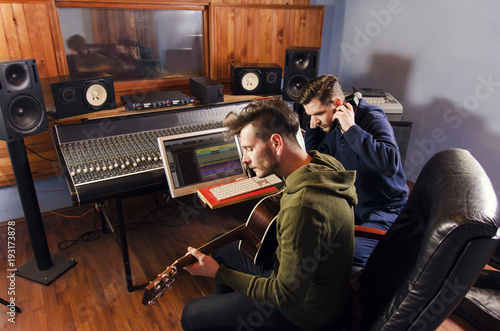 Music Producer And Artist With Acoustic Guitar Together In Music