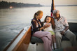 © Erickson Stock - Mature adult couple sitting with their young granddaughter while on a boat.
