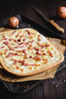 Traditional Tarte flambée with crème fraiche, cheese, onion and bacon