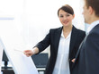 © ASDF - business woman showing a business team information on the flipchart