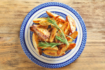 Sticker - Plate with tasty potato wedges on table