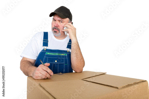 Fotografia, Obraz Serious worker frowning as he talks on his mobile