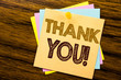 Conceptual hand writing text caption inspiration showing Thank You. Business concept for Thanks Message written on sticky note paper on the wooden background.