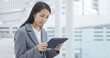 © leungchopan - Businesswoman work on tablet at outdoor