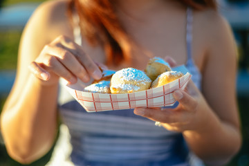 young woman eating fried oreos