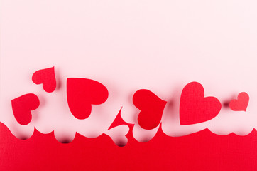 Wall Mural - Valentine day background of red paper hearts on pink color backdrop.