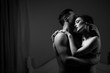 Side view image of two attractive people. Embracing passionately