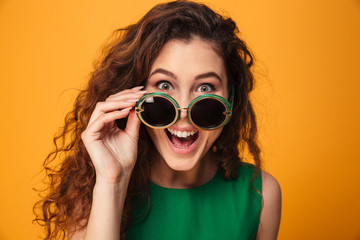 Excited young woman wearing sunglasses.