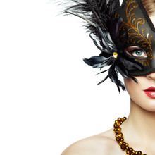 Beautiful Young Woman In Mysterious Black Venetian Mask. Fashion Photo. Masquerade Mask With Black Feathers