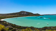 A View Of Kraalbaai In The West Coast National Park In South Africa. The Sea Is A Beautiful Turquoise Colour With Some Boats On The Water