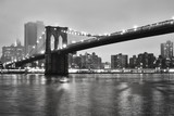 Fototapeta  - Brooklyn Bridge and the Manhattan on a foggy night, New York City, USA.