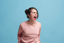 The Young Emotional Angry Woman Screaming On Blue Studio Background