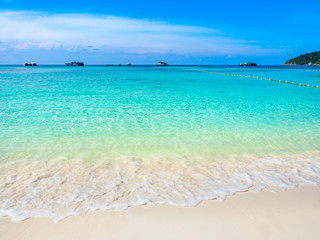 Wall Mural - Turquoise sea wave and white sand beach with clear blue sky in sunny summer day at Koh Lipe,Thailand.