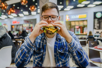 man eat burger in mall cafe