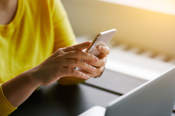 Wall Mural - woman with mobile phone and laptop in office