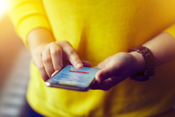 Wall Mural - woman signs up to banking with her mobile phone in the office