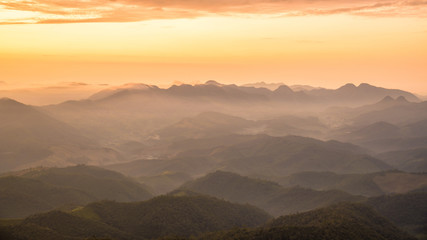Wall Mural - amazing beautiful color sunrise scenic view of mountain landscapes with layer of mountains and fog
