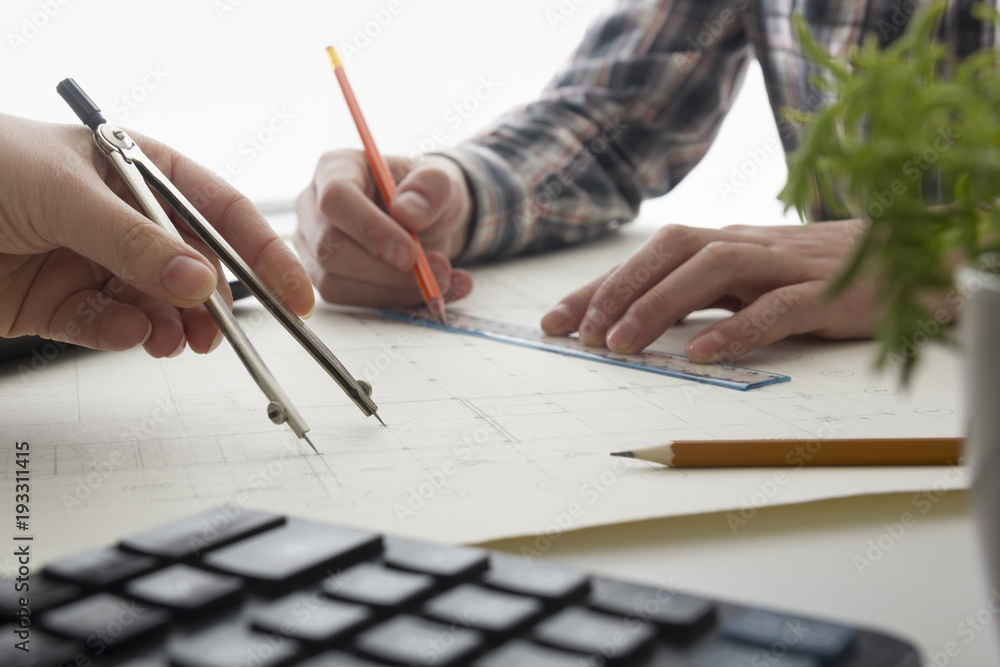 Architects working on blueprint, real estate project. Architect ...