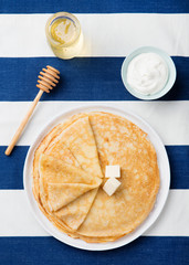Wall Mural - Thin crepes or pancakes with butter and sour cream