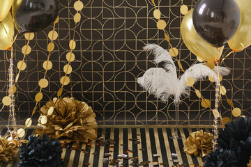 Party decor. Golden decoration on black background with ballons