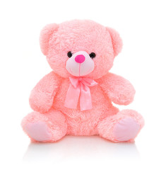 cute pink bear doll with bow isolated on white background with shadow reflection. playful bright pin